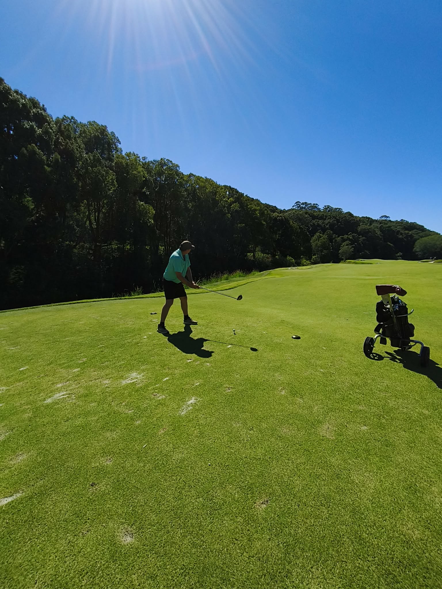 Golfer teeing off on a stunning course